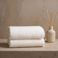 Set of two white Sedona waffle bath towels by Italic, showing soft, textured fabric for home bathroom use.