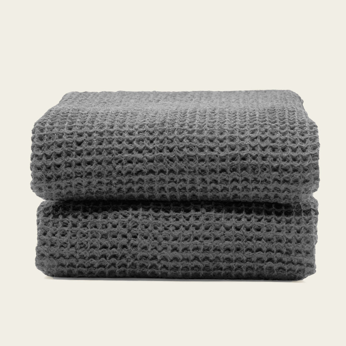 Set of two white Sedona Waffle Towels by Italic, plush bath towels with a textured waffle weave, shown folded on a white background.