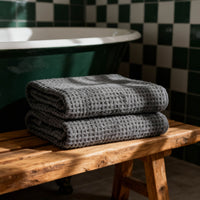 Set of two white Sedona waffle bath towels from Italic, soft and textured for home use.