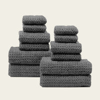 Set of two white Sedona waffle towels for bath by Italic, soft textured home bath linens, folded and stacked.