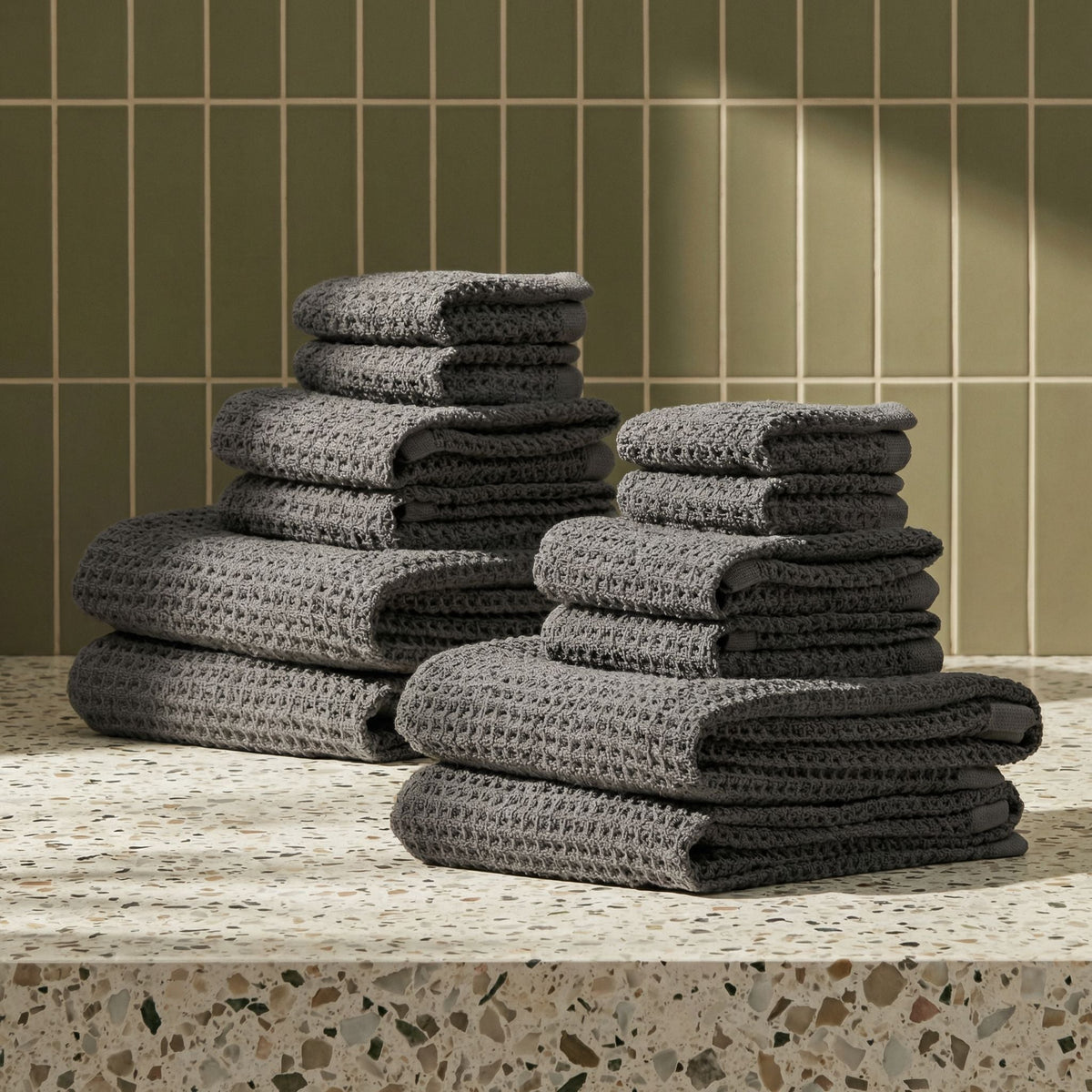 Set of two white Sedona waffle bath towels by Italic, soft and textured for home use, shown folded and hanging.