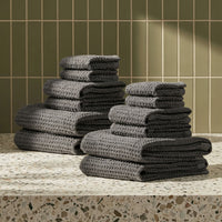 Set of two white Sedona waffle bath towels by Italic, soft and textured for home use, shown folded and hanging.