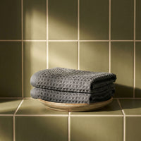 Set of two white Sedona waffle bath towels by Italic, showing soft, textured fabric in a home bathroom setting.