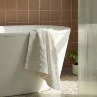 Set of two white Sedona waffle bath towels by Italic, soft and textured for home bath use.