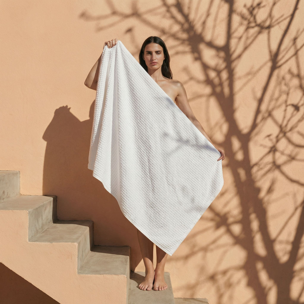Set of two white Sedona waffle bath towels by Italic, soft and textured for home bathroom use.
