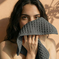 Set of two white Sedona waffle towels for bath from Italic, soft and textured home bath towels, close-up of fabric detail.