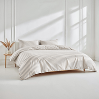 Blue and white Luxe Australian Sateen Bedding Bundle by Italic on a bed, showcasing smooth, luxurious satin bedding for a home bedroom setting.