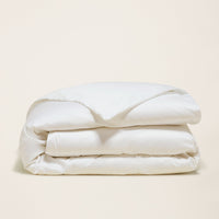 Blue and white Luxe Australian Sateen Bedding Bundle from Italic, featuring soft, luxurious twin bed linens with elegant patterns.