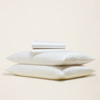 Blue and white Luxe Australian Sateen Bedding Bundle by Italic, featuring a cozy twin bed with smooth satin sheets and pillowcases.