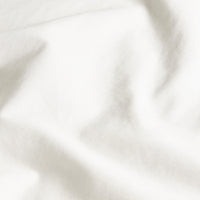 Blue and white Luxe Australian Sateen Bedding Bundle from Italic on a bed, showcasing smooth, luxurious satin fabric in a cozy home setting.