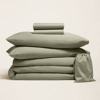 Blue and white Luxe Australian Sateen Bedding Bundle from Italic, featuring a cozy twin bed with smooth, luxurious sheets and pillowcases.