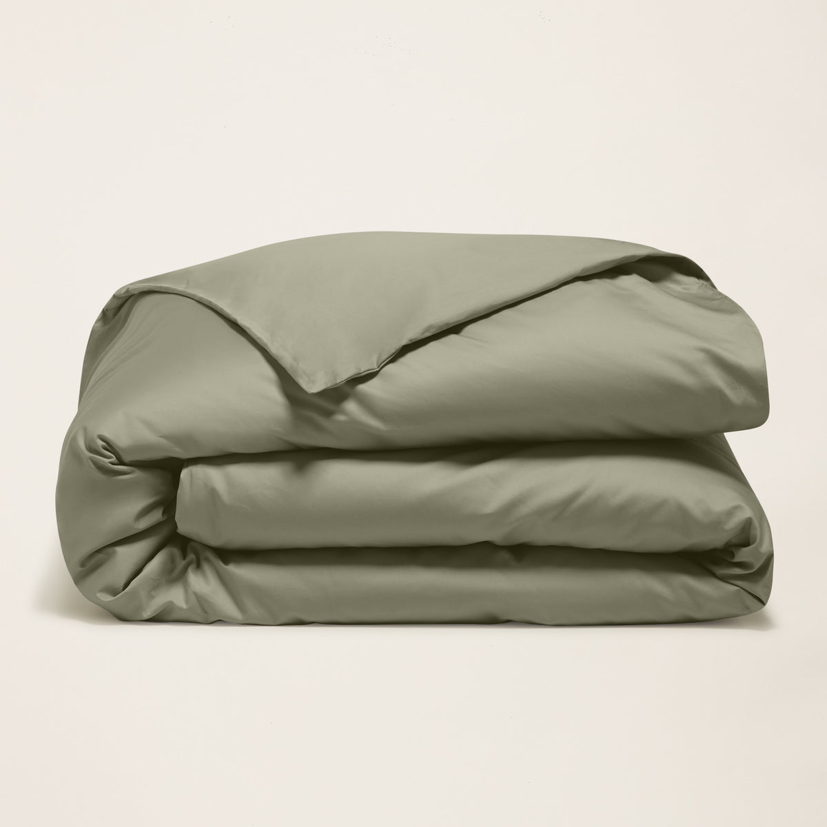 Blue and white Luxe Australian Sateen Bedding Bundle by Italic on a bed, featuring smooth satin sheets and pillowcases in a twin size.