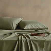 Blue and white Luxe Australian Sateen Bedding Bundle by Italic on a bed, showcasing smooth, luxurious satin bedding.