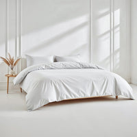 Blue and white Luxe Australian Sateen bedding bundle by Italic on a bed, featuring soft, smooth sateen sheets and matching pillowcases.