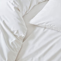Blue and white Luxe Australian Sateen Bedding Bundle by Italic on a bed, showcasing soft, luxurious satin fabric in a twin size.