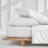 Blue and white Luxe Australian Sateen Bedding Bundle by Italic, featuring a twin bed with soft, luxurious sateen sheets and pillowcases.