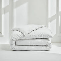 Blue and white Luxe Australian Sateen Bedding Bundle from Italic on a bed, showcasing smooth, luxurious satin fabric and twin size bedding.