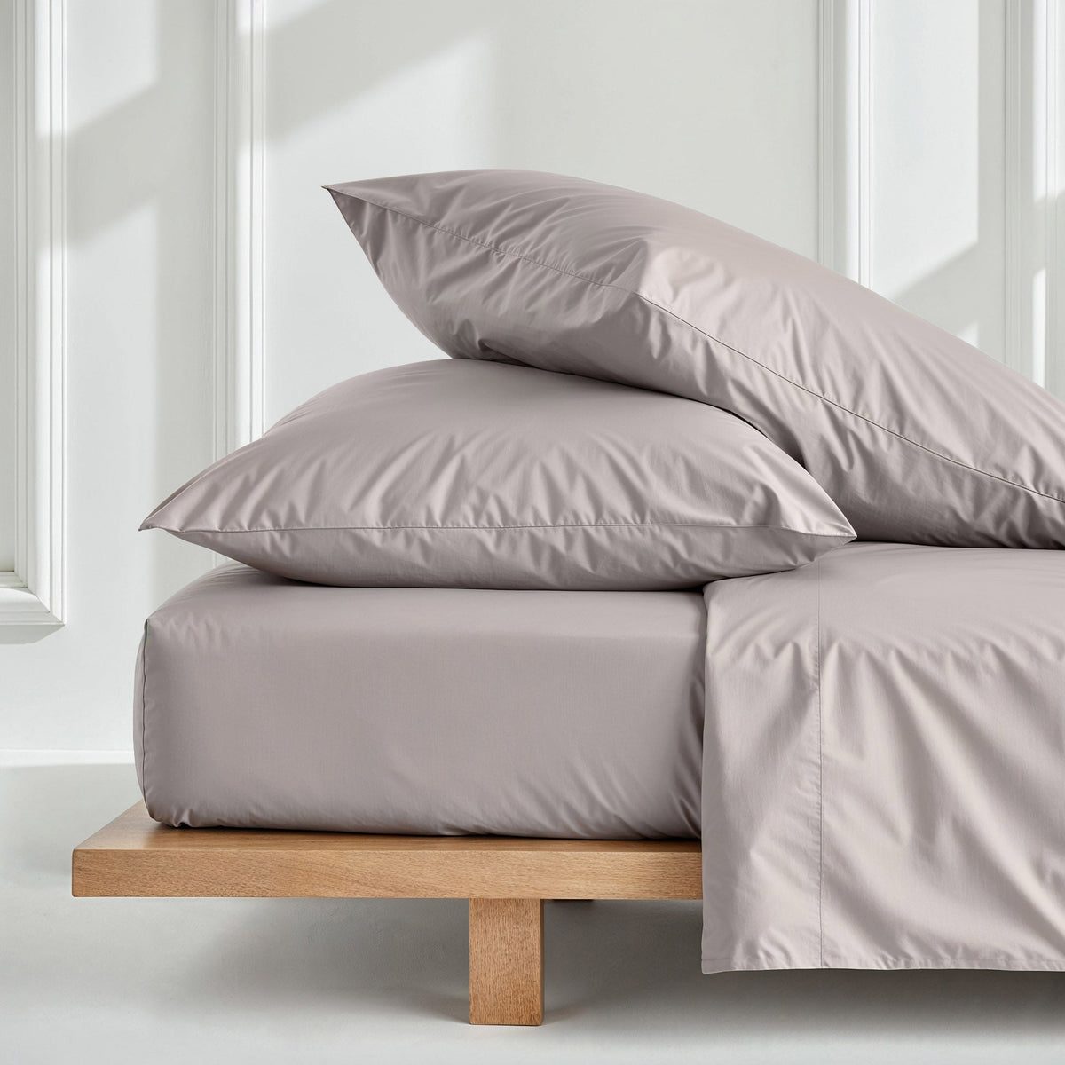 Blue and white Luxe Australian Sateen Bedding Bundle by Italic on a bed, showcasing smooth, luxurious satin fabric in a home bedroom setting.