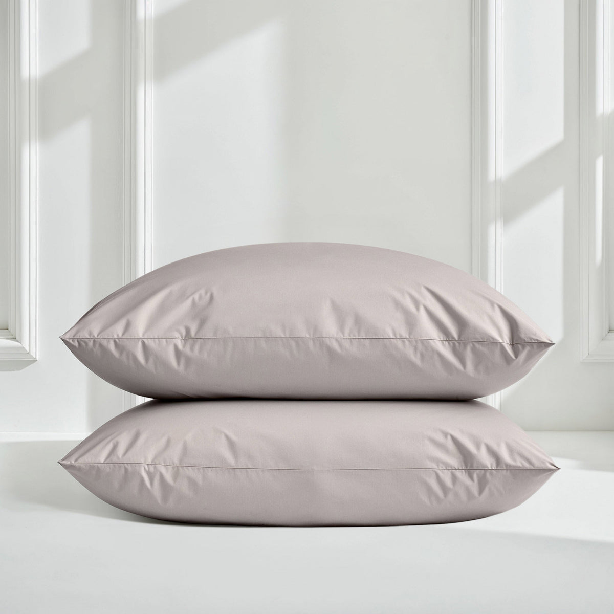 Blue and white Luxe Australian Sateen Bedding Bundle by Italic on a bed, featuring smooth, luxurious satin sheets and pillowcases.