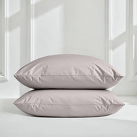 Blue and white Luxe Australian Sateen Bedding Bundle by Italic on a bed, featuring smooth, luxurious satin sheets and pillowcases.