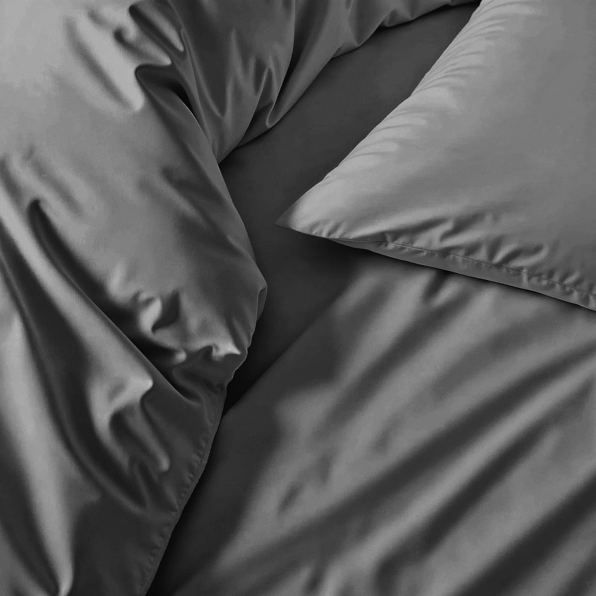 Blue and white Luxe Australian Sateen Bedding Bundle from Italic, featuring soft, luxurious twin bed sheets and pillowcases.