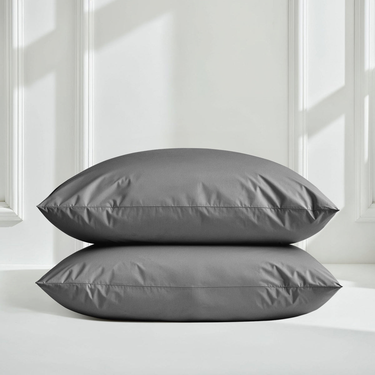 Italic Luxe Australian Sateen Bedding Bundle on twin bed featuring soft blue and white sateen sheets and pillowcases.