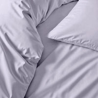 Blue and white Luxe Australian Sateen Bedding Bundle by Italic on a twin bed, showcasing smooth, luxurious satin fabric.