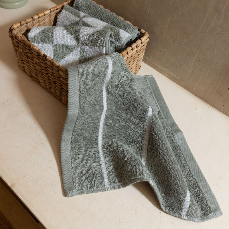 Set of two Italic Deia sage and ecru bed towels with soft, plush texture for home use.