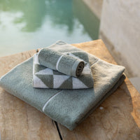 Set of two Italic Deia home bed washcloths in sage and ecru, soft and plush towel set for bathroom use.