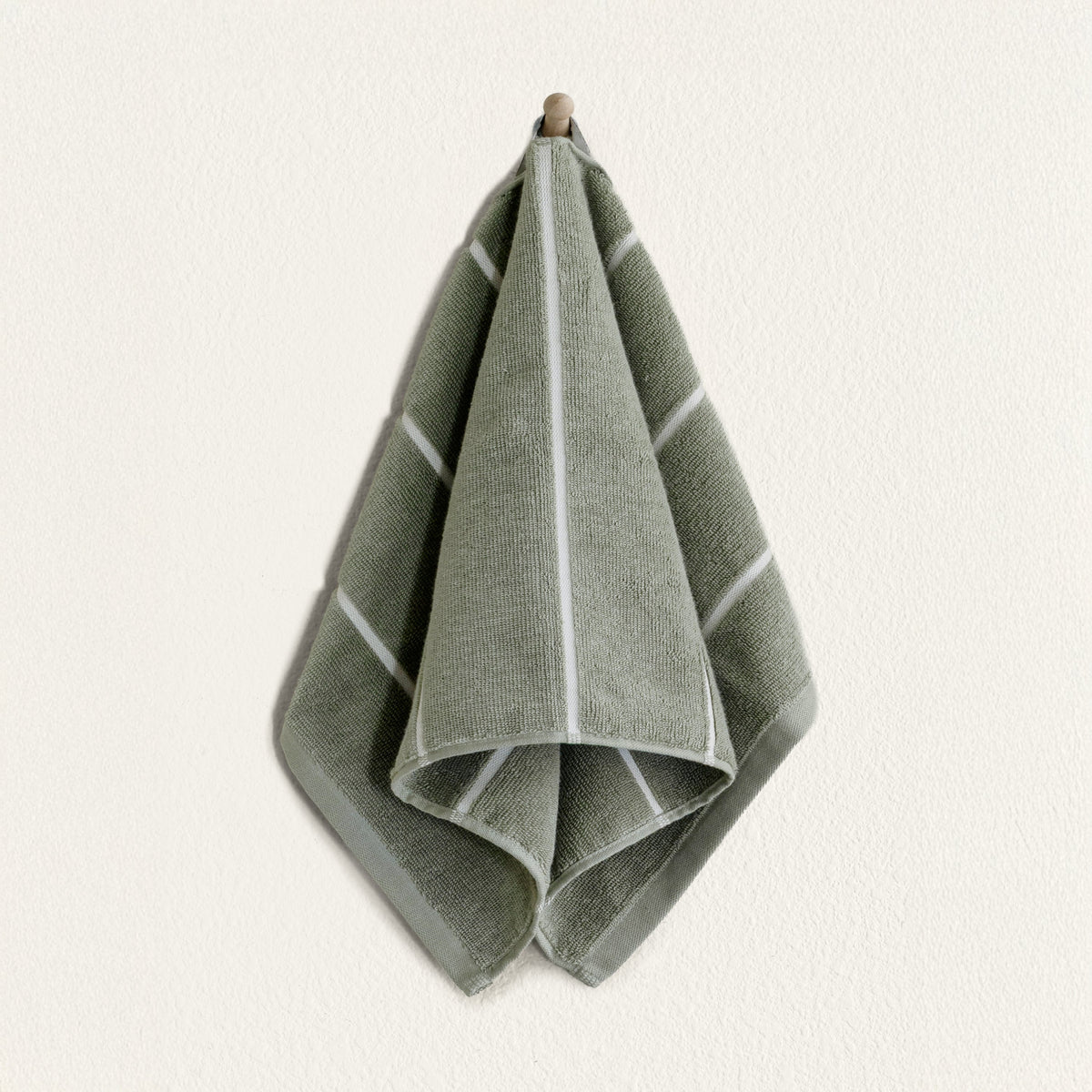 Set of two Italic Deia Towels for bed, sage and ecru washcloths with soft, plush texture, ideal for home use.
