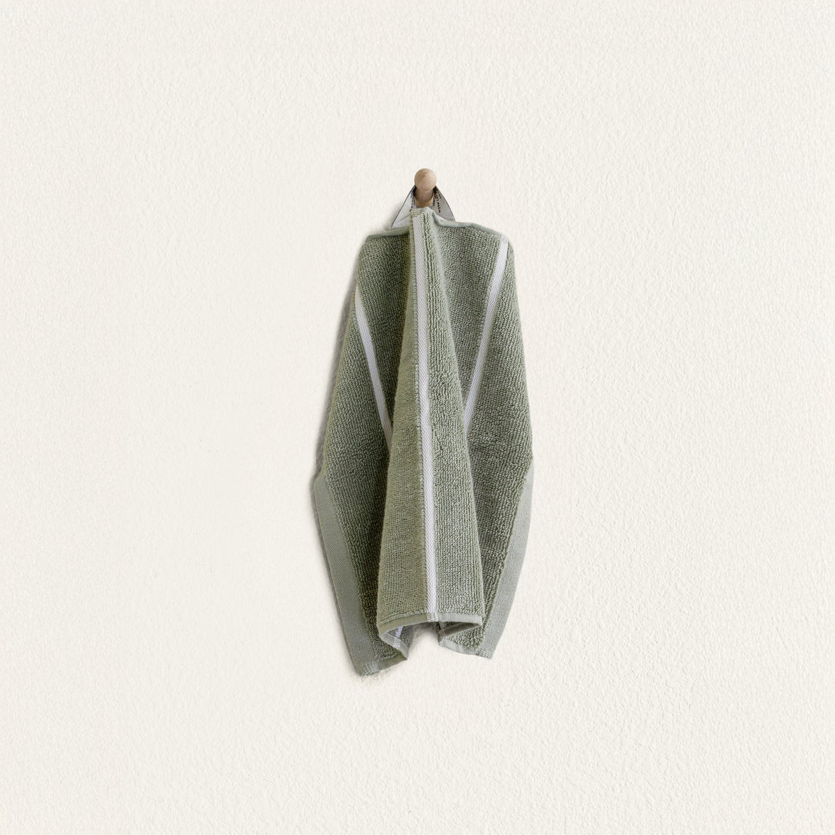 Set of two Italic Deia towels in sage and ecru, soft home bed linens with a luxurious, cozy texture.