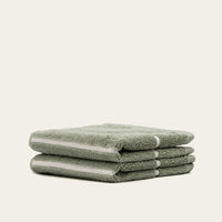 Set of two Italic Deia sage and ecru bed towels, soft woven home textiles with a modern, minimalist design.