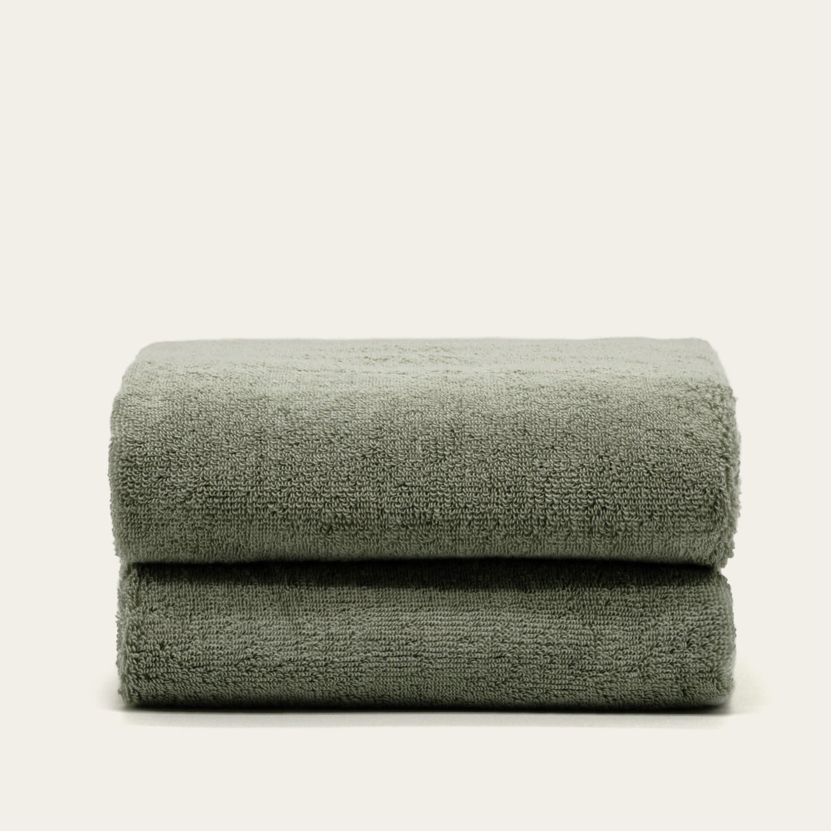 Set of two Italic Deia home bed towels in sage and ecru, soft washcloths for bathroom or bed linens.
