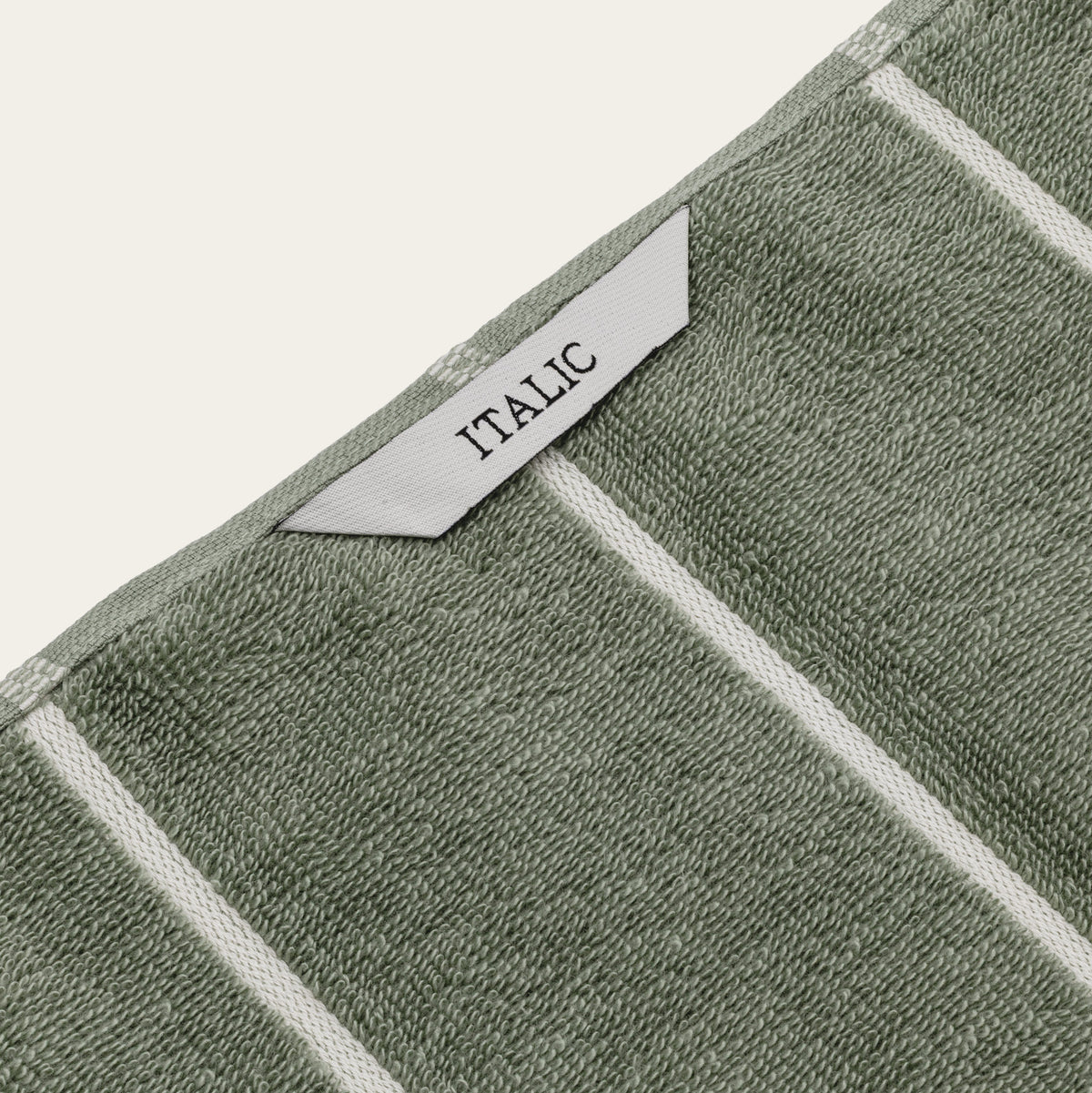 Set of two Italic Deia sage and ecru bed towels, soft and plush home bedding towels with woven texture.