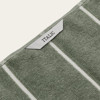 Set of two Italic Deia sage and ecru bed towels, soft and plush home bedding towels with woven texture.