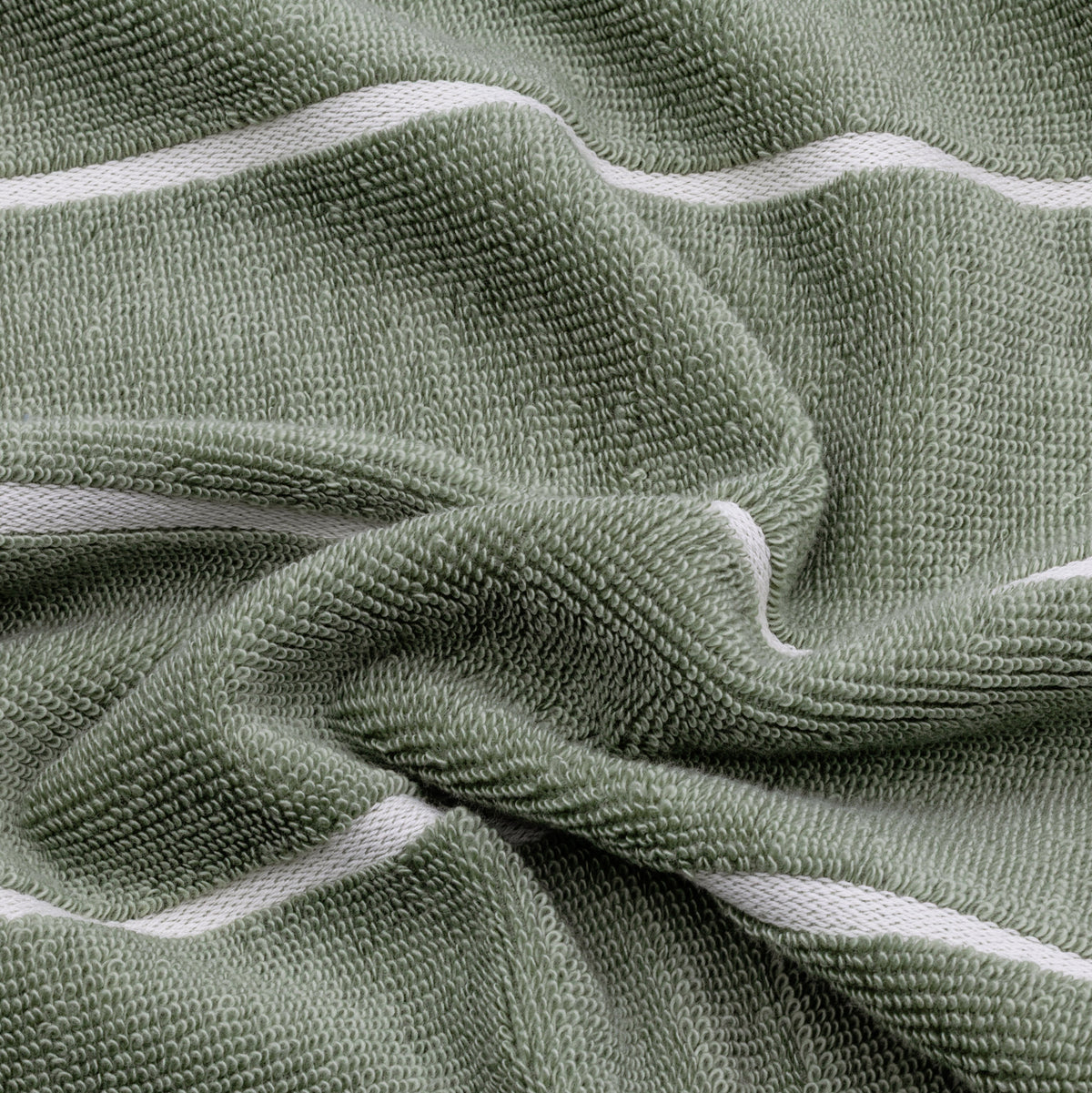 Set of two Italic Deia bed towels in sage and ecru, soft home bedding with plush fabric and subtle woven texture.