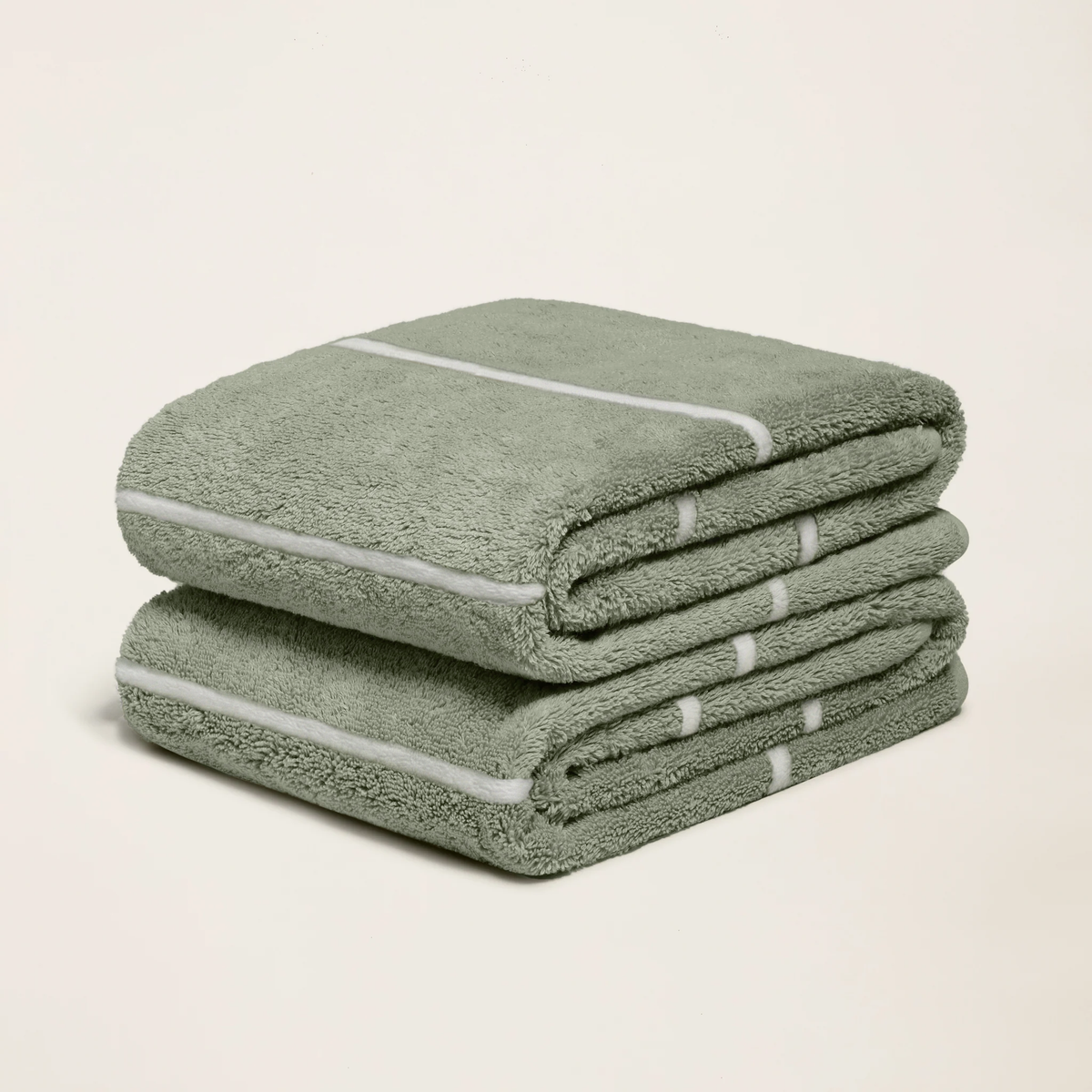 Set of two Italic Deia sage and ecru bed towels featuring soft, plush fabric for home bedding comfort.