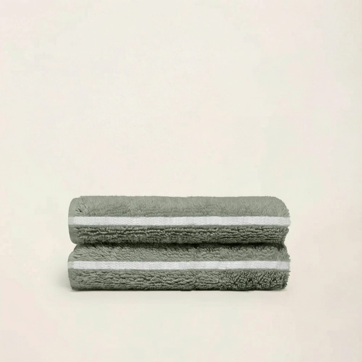 Set of two Italic Deia home bed towels in sage and ecru, soft fabric perfect for bed or bath use.