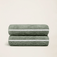 Set of two Italic Deia towels in sage and ecru, soft home bed washcloths with a cozy, textured appearance.