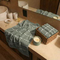Set of two Italic Deia Towels for home bed in sage and ecru, soft washcloths with a plush, luxurious texture.