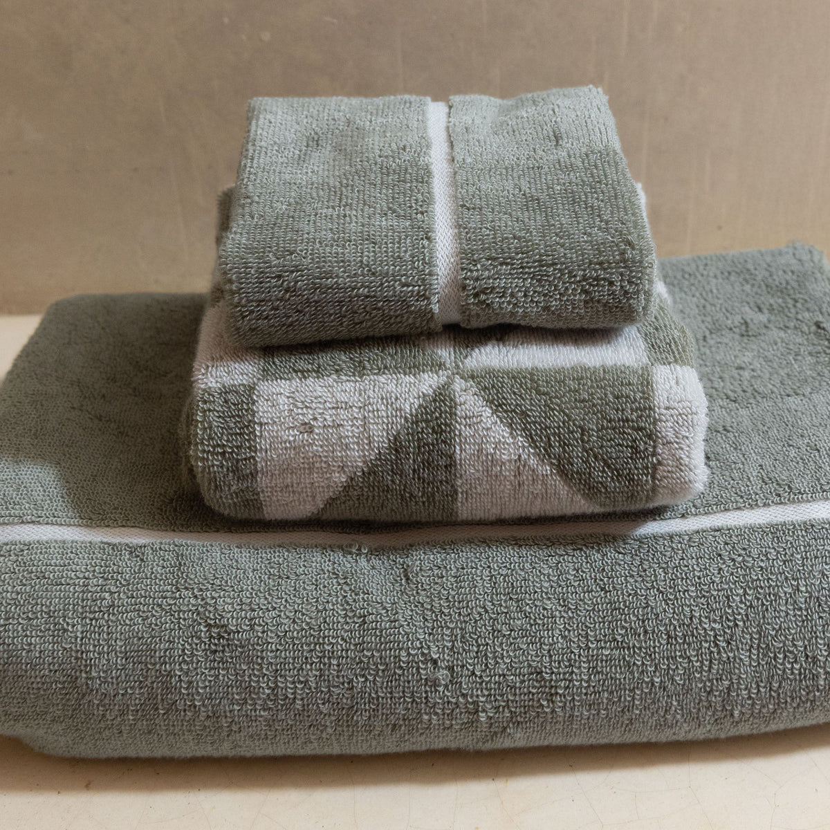 Set of two Italic Deia sage and ecru bed towels with a soft, plush texture, designed for home and bed use.