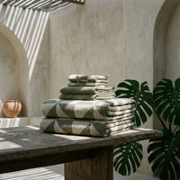 Set of two Italic Deia sage and ecru bed towels with soft, plush fabric for home use.