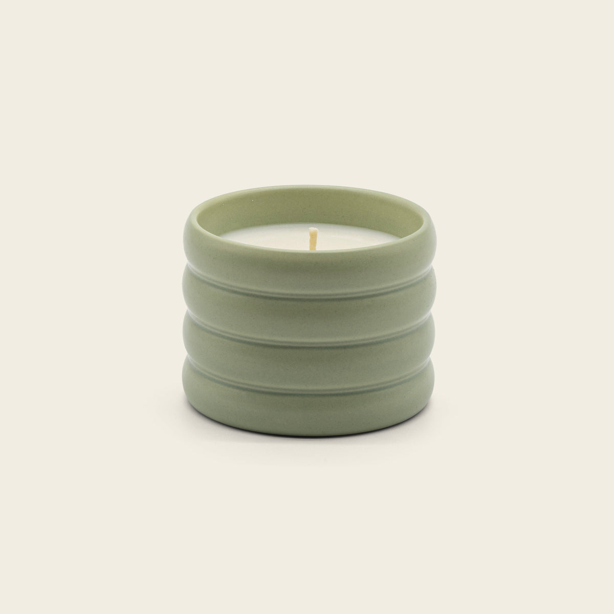 Italic Matcha Bloom ceramic candle in a white ceramic holder with a floral design, showcasing a calming and elegant decorative candle.