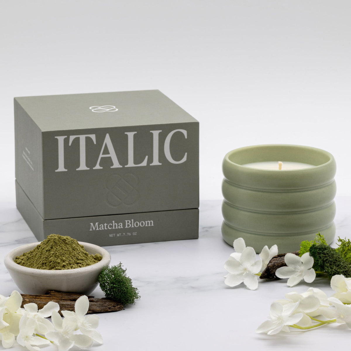 Italic Matcha Bloom ceramic candle in a stylish white ceramic holder with a lit wick and fresh floral scent.