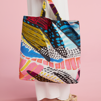 Cotton farmers' market tote bag with "Cliche" print, durable fabric, and sturdy handles for shopping and everyday use.