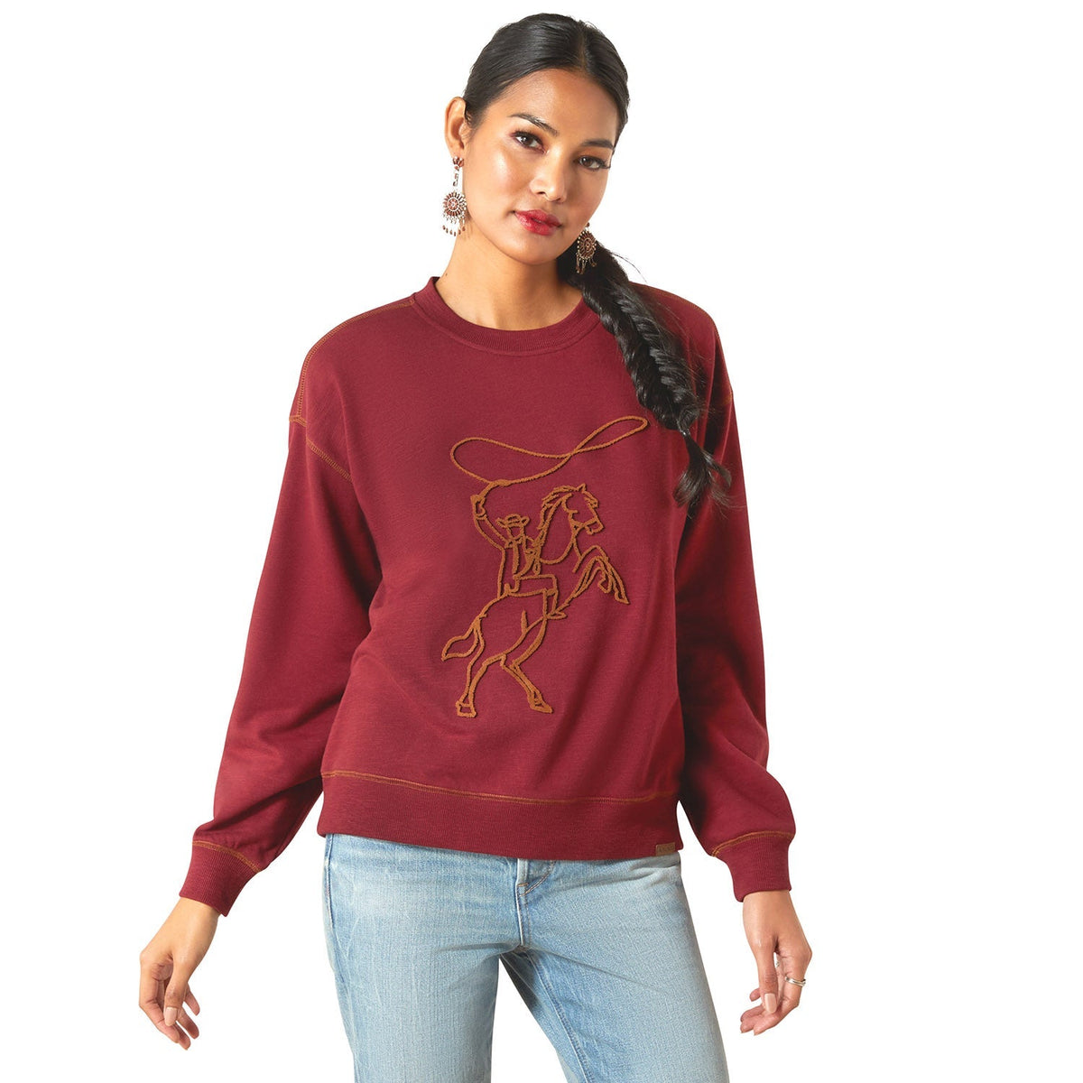 A woman wearing the Ariat Lasso Sweatshirt, a casual, cozy women's jacket with a hood and front pocket, in a neutral color.