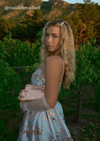 Blue Arabella Dress by JessaKae, featuring a flowing fabric and elegant design, displayed on a model.
