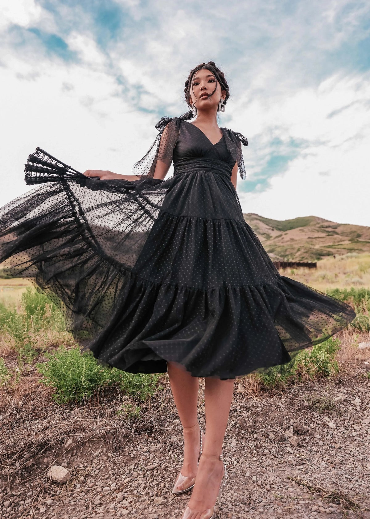 Black Jeanne Dress by JessaKae, showing a fitted, sleeveless dress with a V-neckline and knee-length hem on a mannequin.