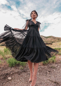 Black Jeanne Dress by JessaKae, showing a fitted, sleeveless dress with a V-neckline and knee-length hem on a mannequin.