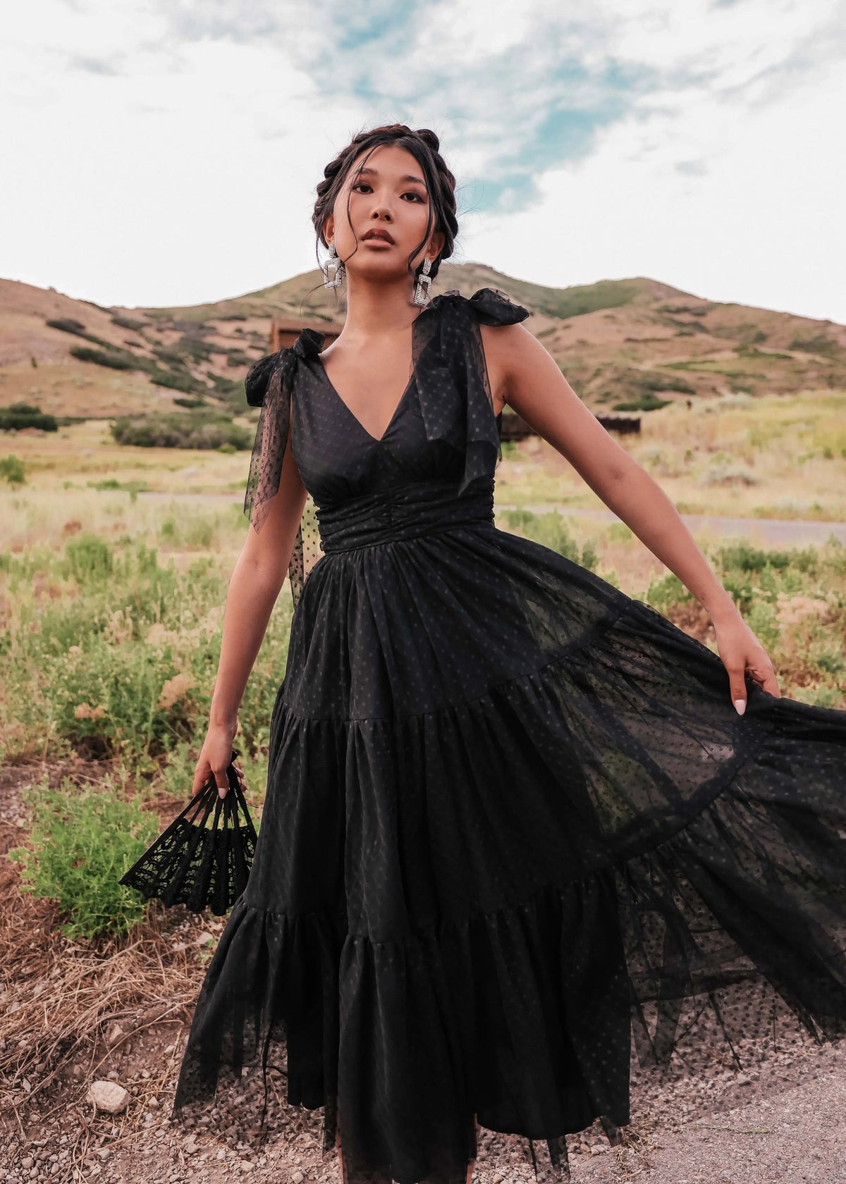 Black Jeanne Dress by JessaKae, featuring a stylish, fitted design with long sleeves and a V-neck, displayed on a mannequin.
